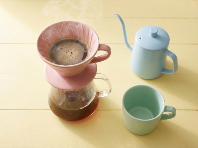 Pink ceramic pour-over dripper steaming on a glass carafe